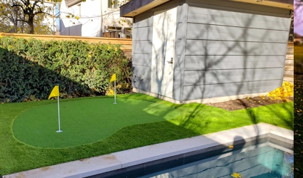 A small putting green installed by Elite Courts next to a shed in a client's backyard in Downtown, Toronto