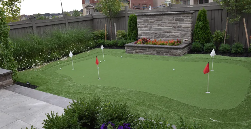 A custom putting green installed in the backyard of a customer's home by Elite Courts