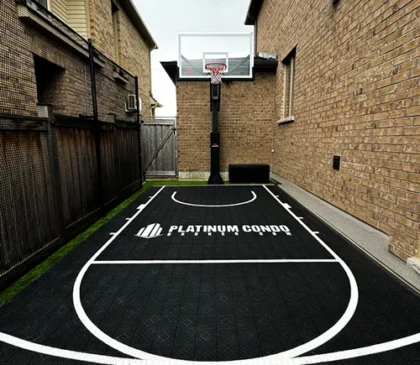 A custom basketball court installed by Elite Courts for Platinum Condo Broker owner in his backyard