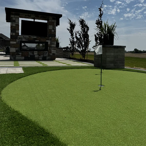 A putting green installed in a client's backyard in the Innis Lake area by Elite Courts